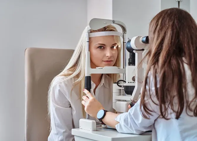 young_blonde_girl_undergoing_vision_examination_at_an_ophthalmologist