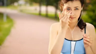 A-woman-touching-her-eye-while-exercising
